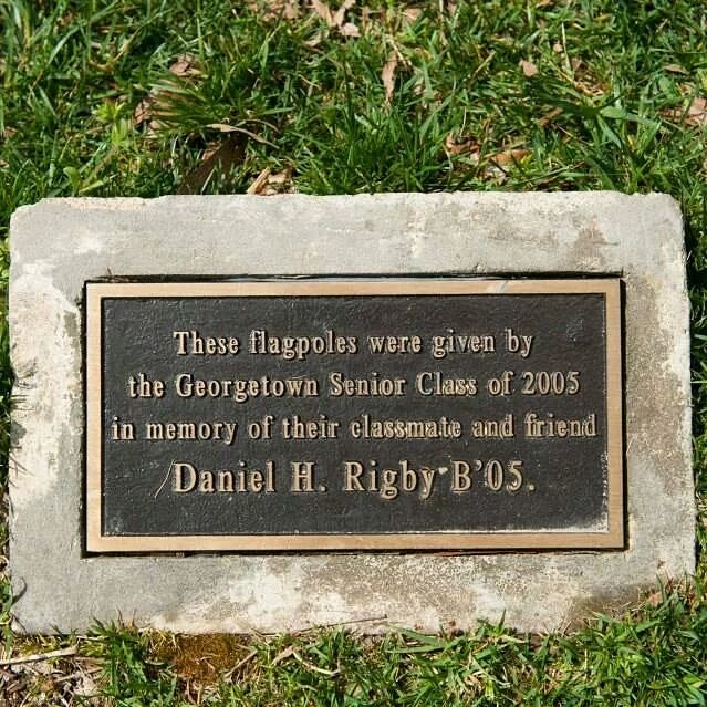 A plaque at the flagpoles given in memory of Daniel Rigby