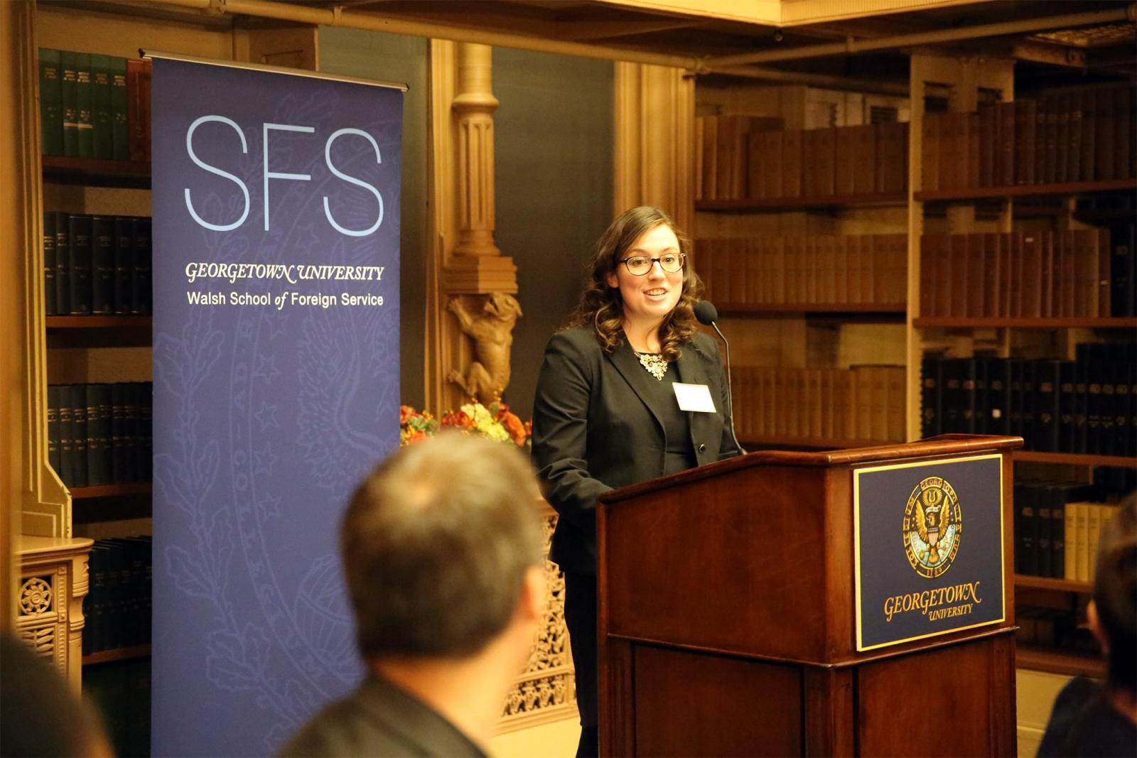 Megan Murday standing at a podium in Riggs Library addressing the SFS Board of Advisors Dinner