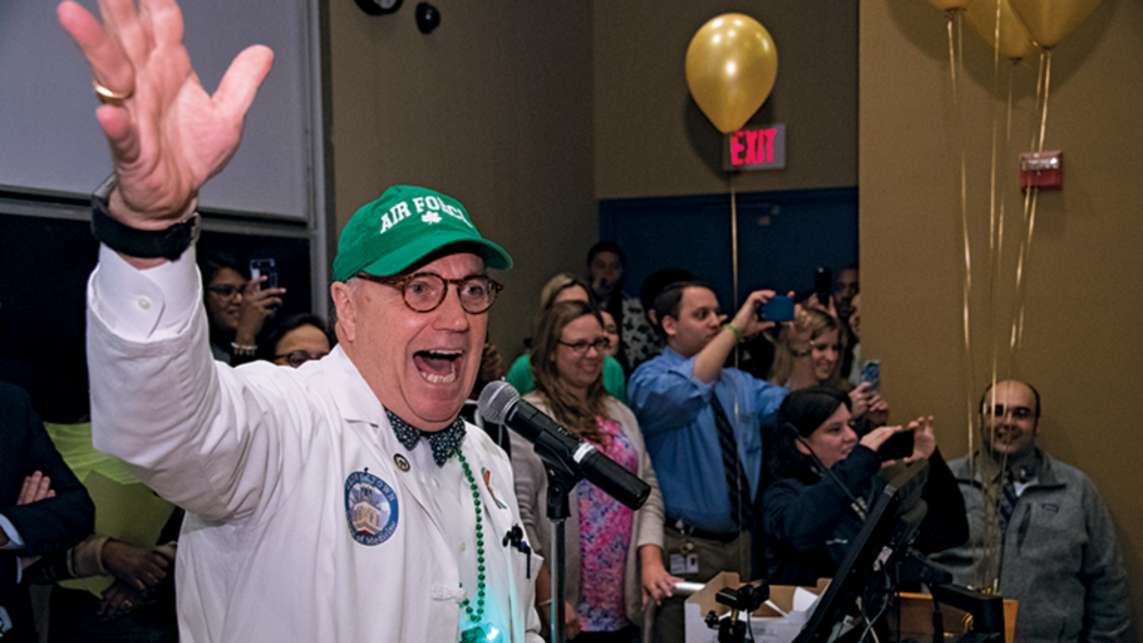 doctor in green hat announcing something happily
