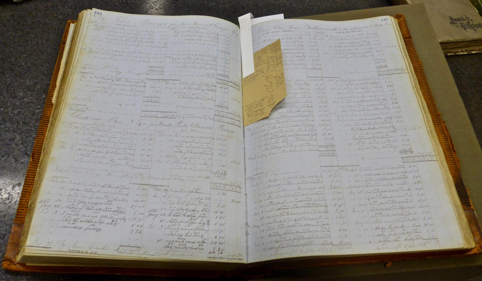 An open log book with writing on the pages