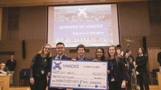 Roisin McLoughlin (C’19) (at right) and her teammates accept a first-place award in the Migrants and Refugees category at VHacks, an event at the Vatican that seeks to use technological innovation to address global problems.