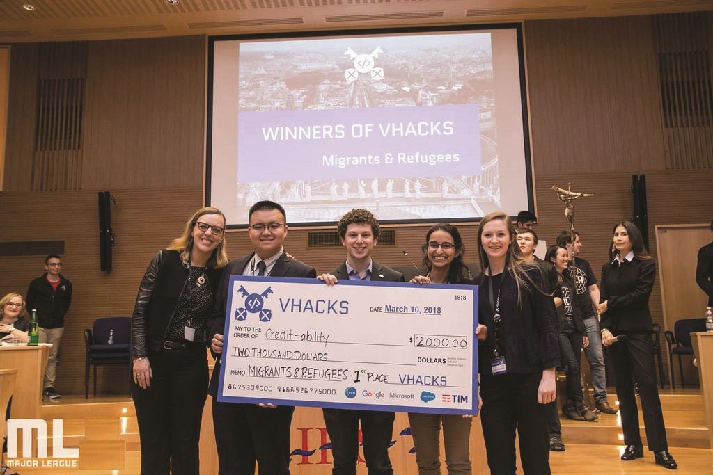 Roisin McLoughlin (C’19) (at right) and her teammates accept a first-place award in the Migrants and Refugees category at VHacks, an event at the Vatican that seeks to use technological innovation to address global problems.