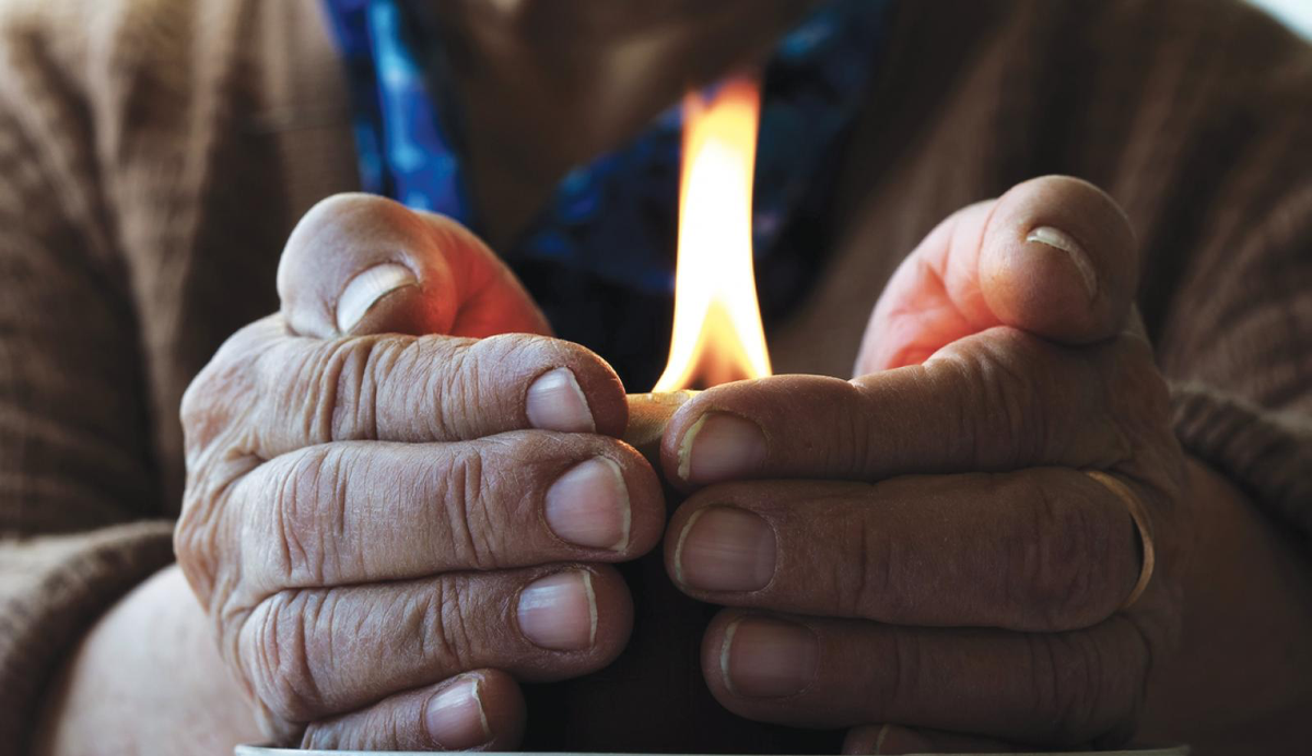 hands around a candle