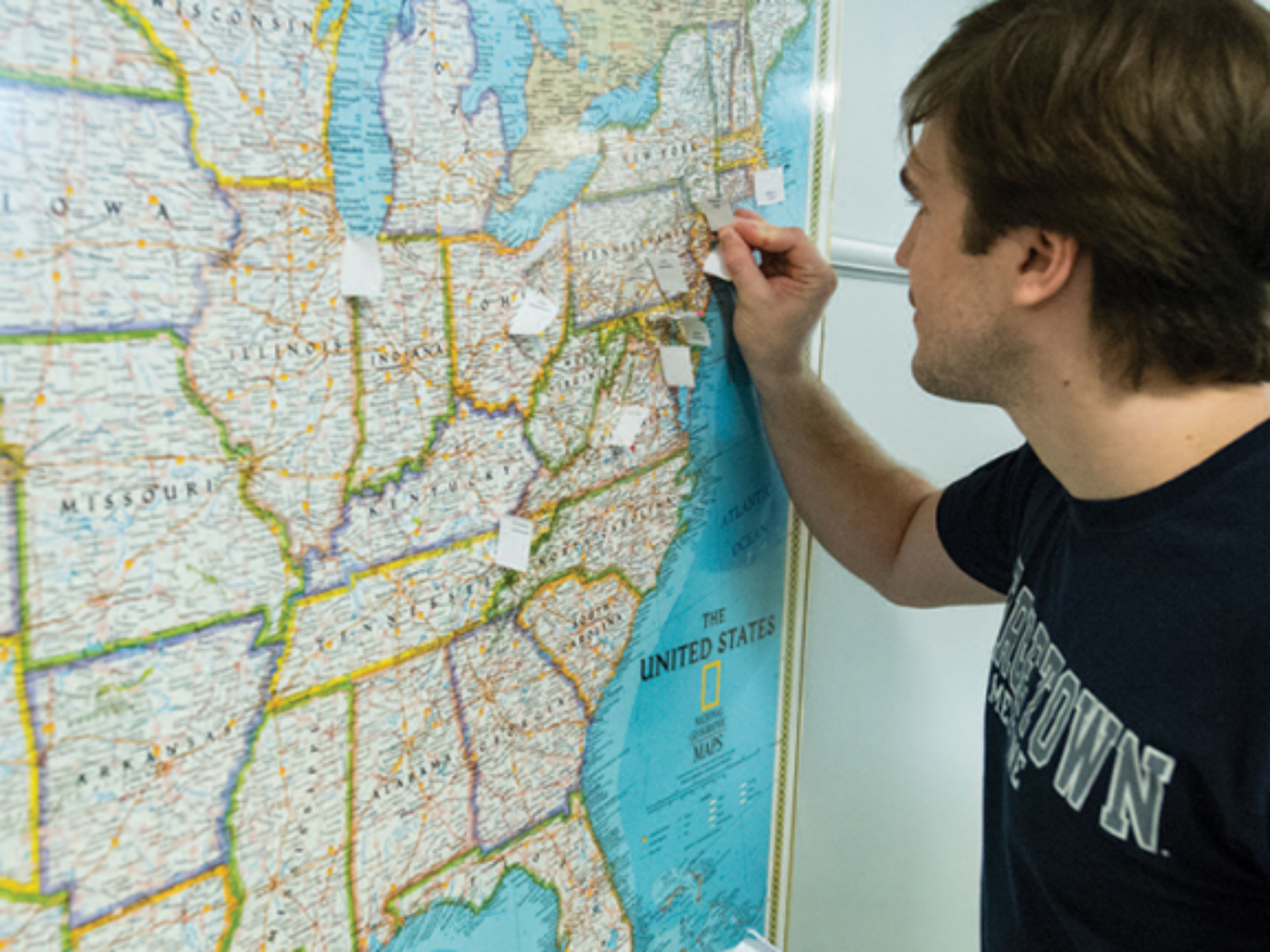 student pinning up where he matched on US map