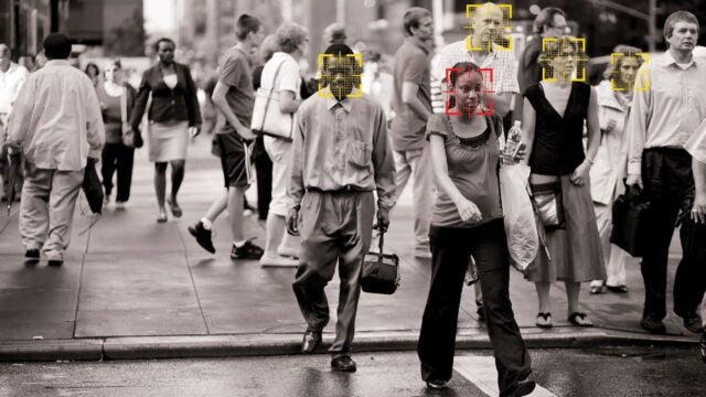 image of people walking with facial recognition targets on their faces