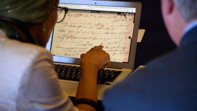 students looking at slavery archival materials on computer screen