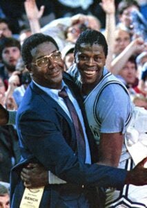 Coach Thompson hugging Patrick ewing on the sideline