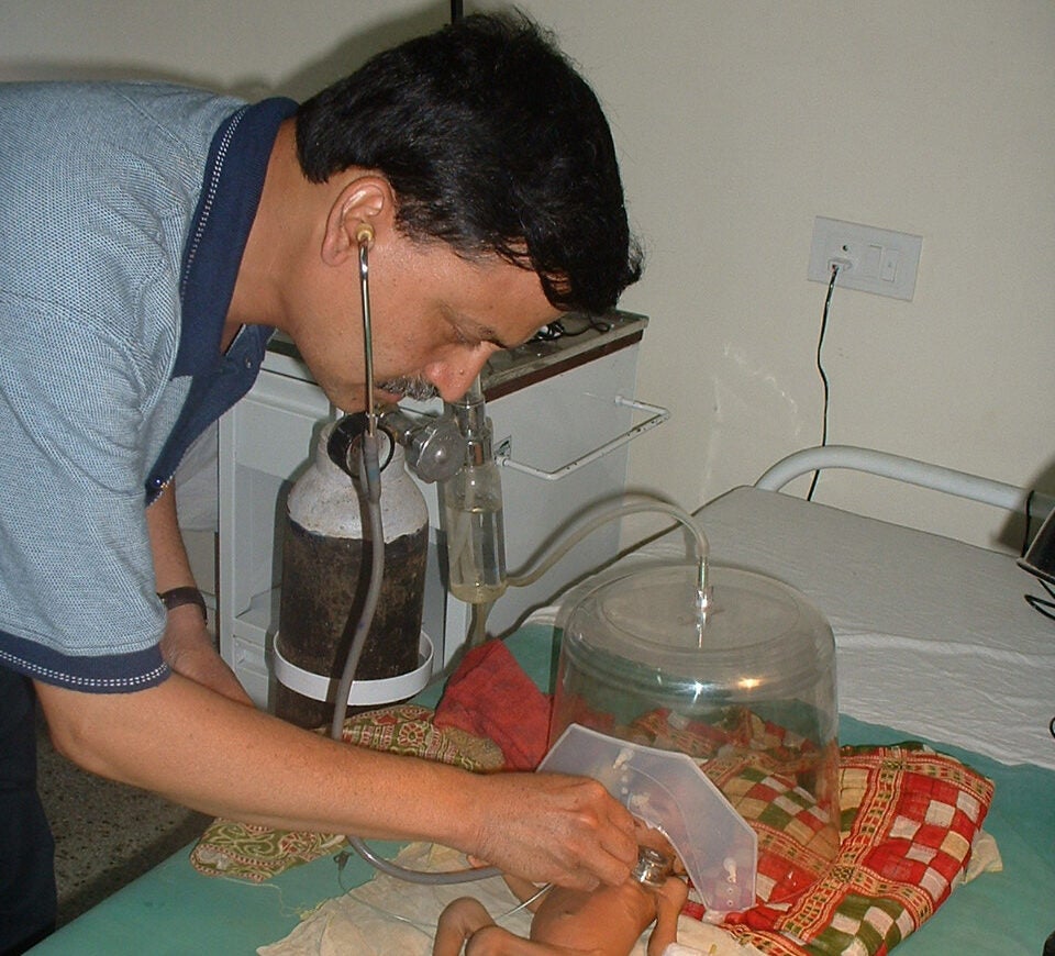 pinaki panigrahi examining a baby
