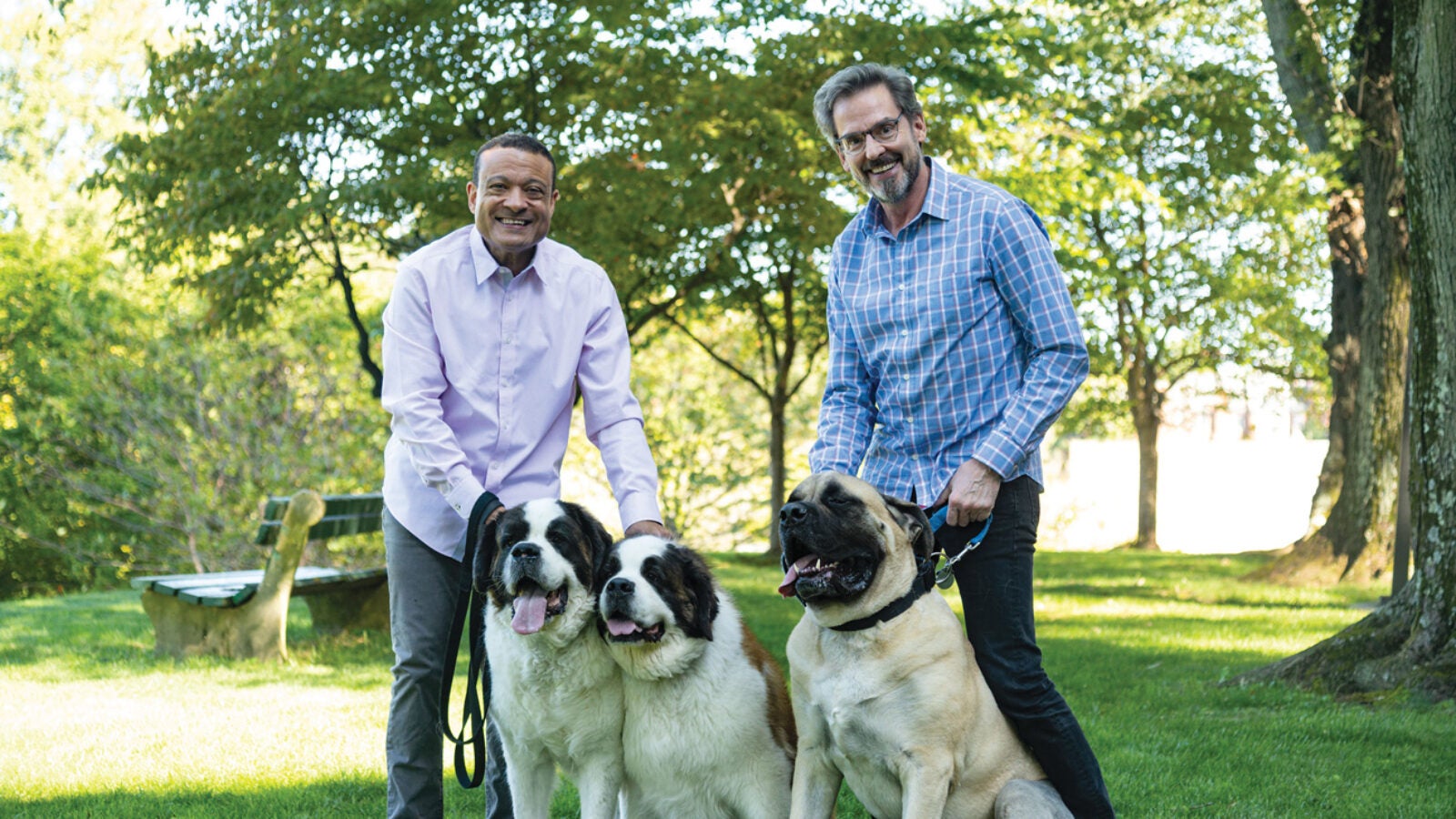 Jones (left) and his husband Bill Flynn, MD (right), along with Angus, Emma, and Toby, enjoy a sunny afternoon on campus.
