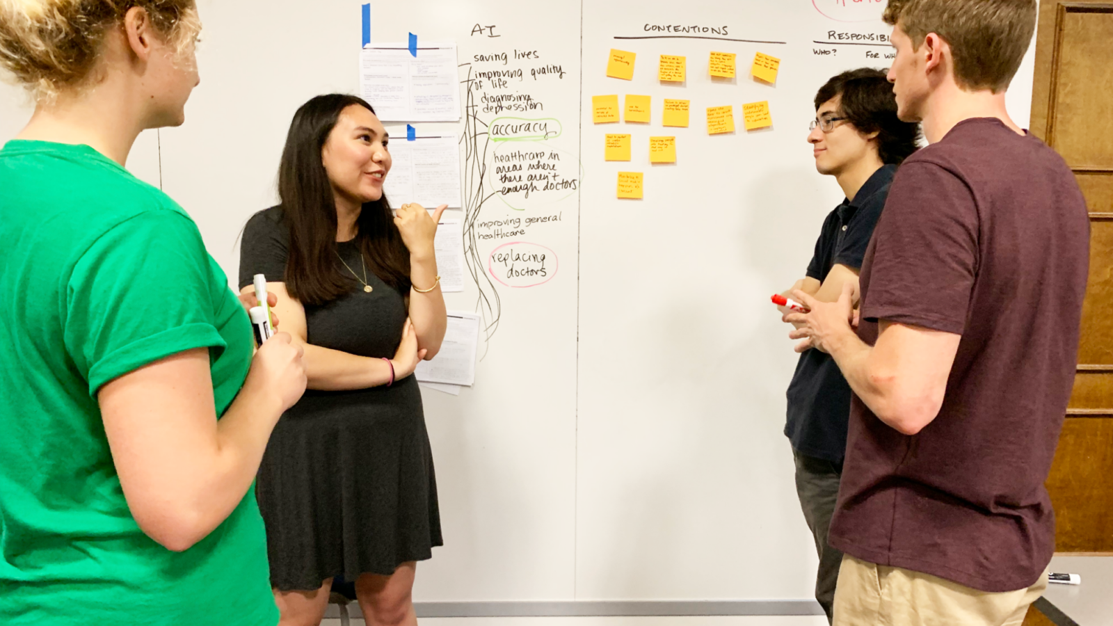 Students in the Fall 2019 Introduction to AI course use a white board and sticky notes in an interactive exercise.