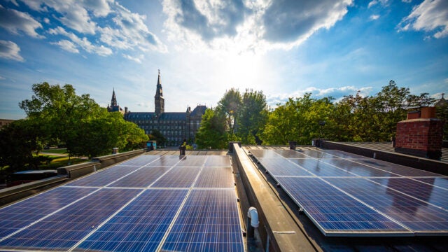 solar panels and row houses with the hilltop in the background