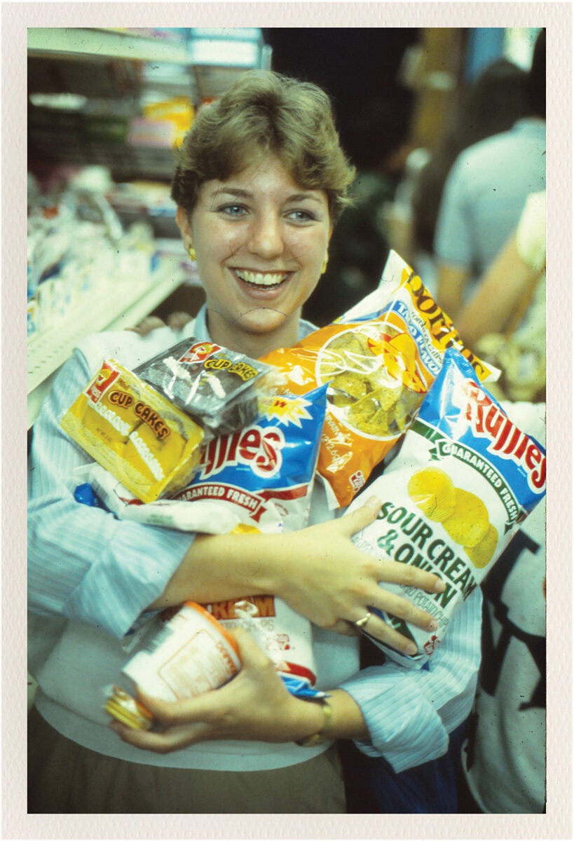 student holding bags of chips