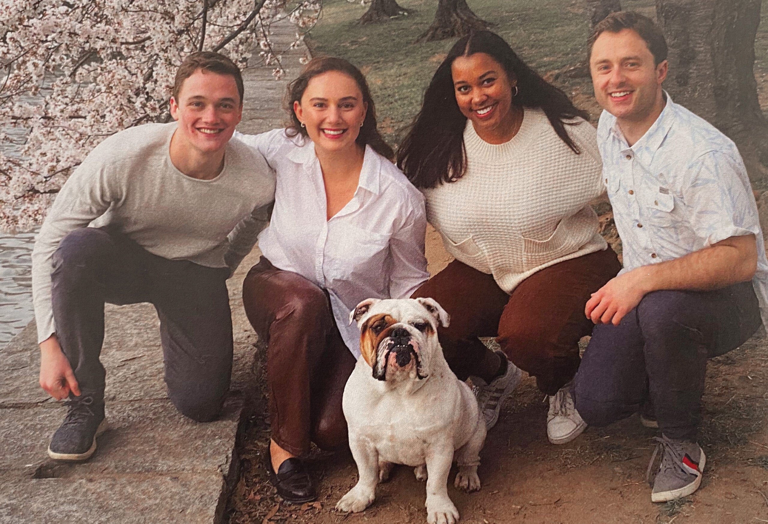 four people sit with Jack the Bulldog