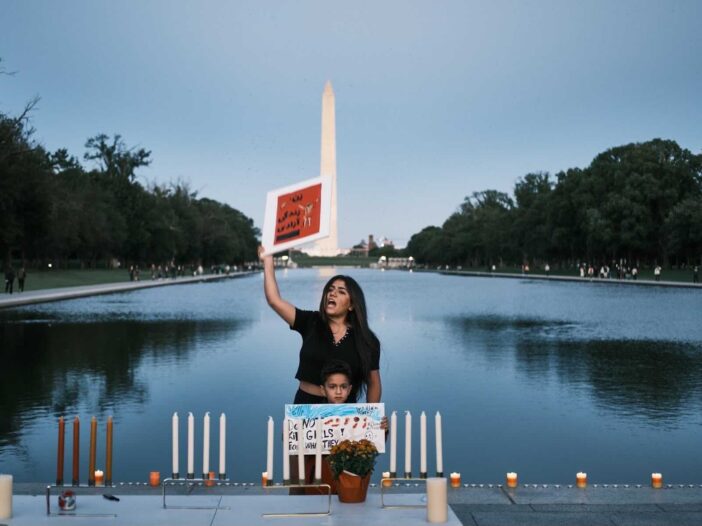 student protesting in front of the washington monument