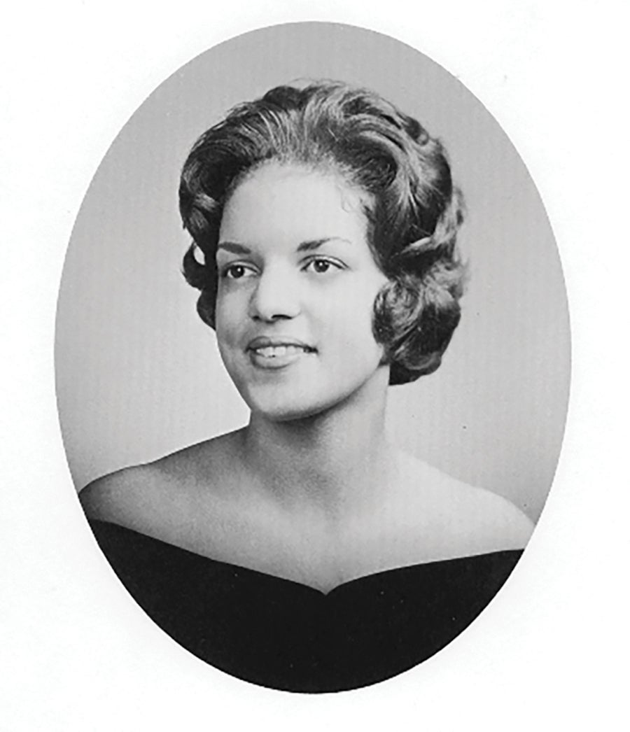 a woman smiles in front of a background (black and white photo)