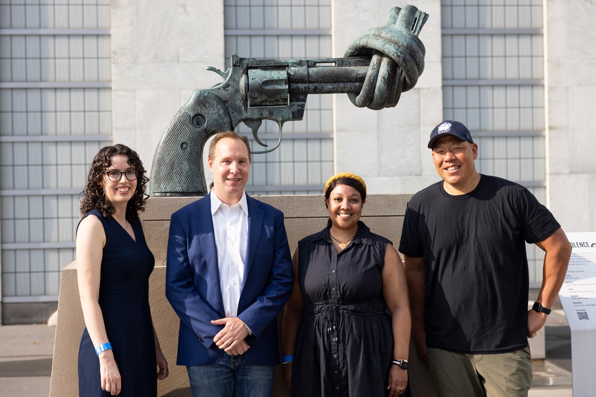 Several Georgetown alumni who work at Everytown For Gun Safety gather at the sculpture “Non-Violence” in front of the UN Headquarters in New York City. Artist Carl Frederk Reutersward created the piece in 1980 in response to the murder of his friend, John Lennon. Left to right: Carolyn Shanahan (C’12), Justin Wagner (C’03, L’06), Monisha Henley (G’10), Len Kamdang (C’98).