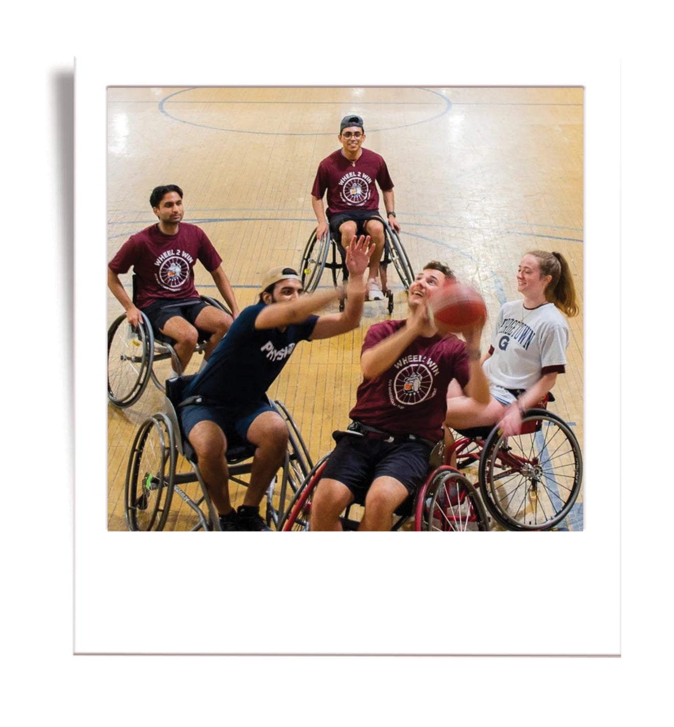 students playing basketball in wheelchairs