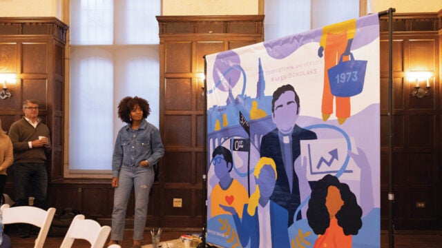 a woman stands in front of an artistic mural