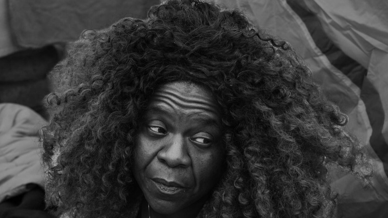 homeless black woman sitting