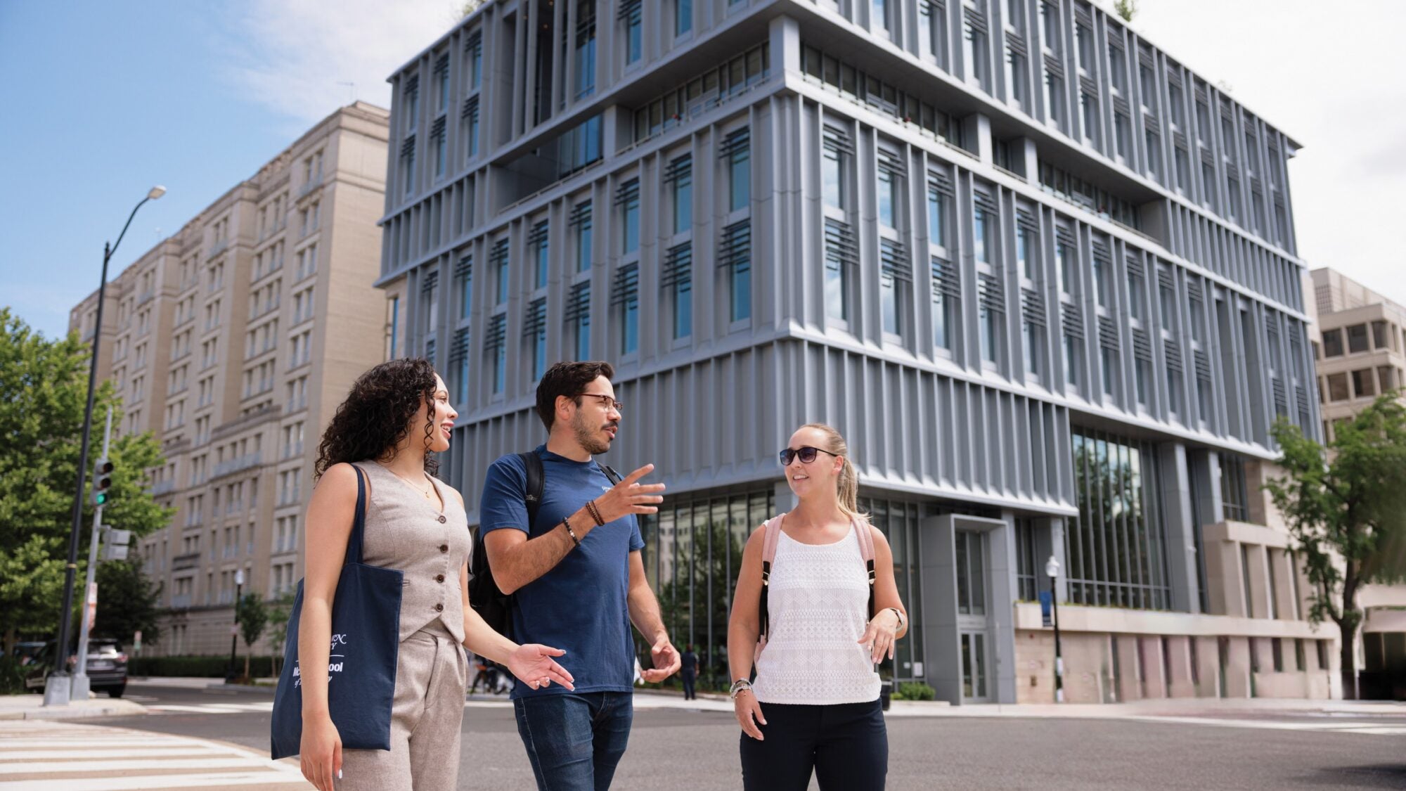 students walking around 124 e campus building