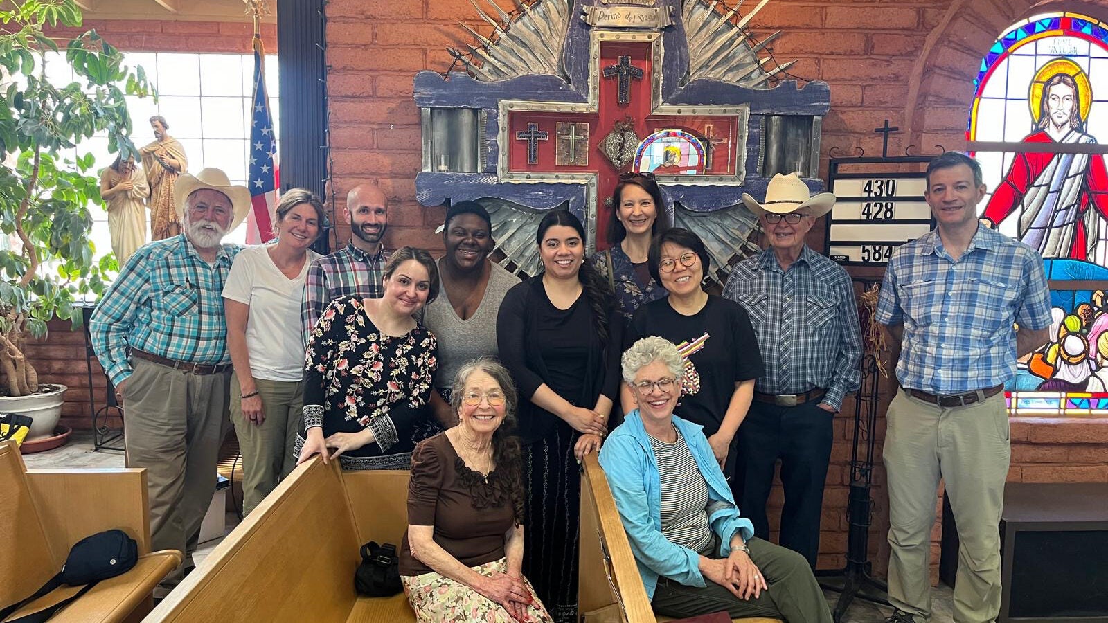 people sit together in church pews