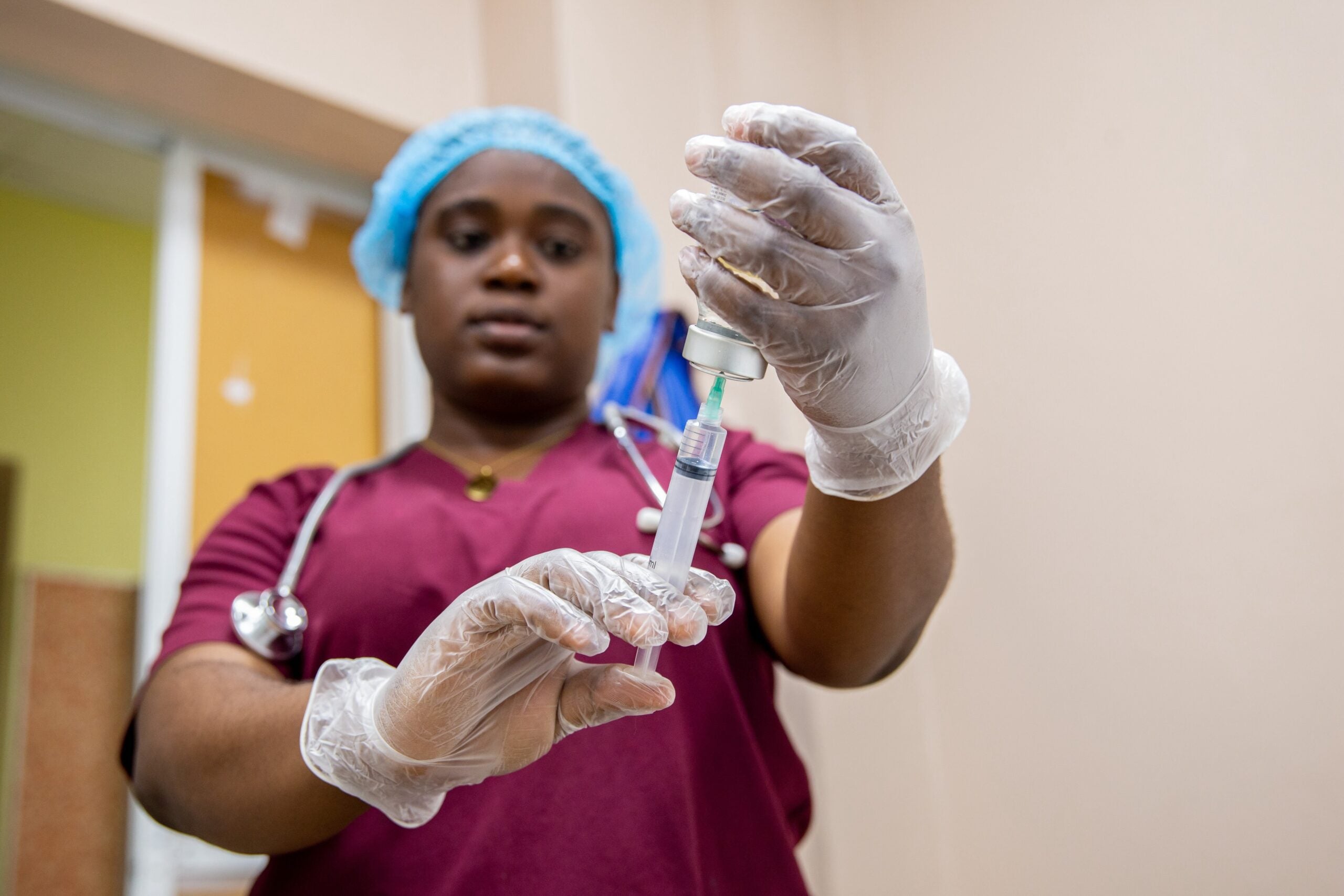 A black nurse holds a syringe in her hand with a medicament in Port-au-prince on October 03, 2023.