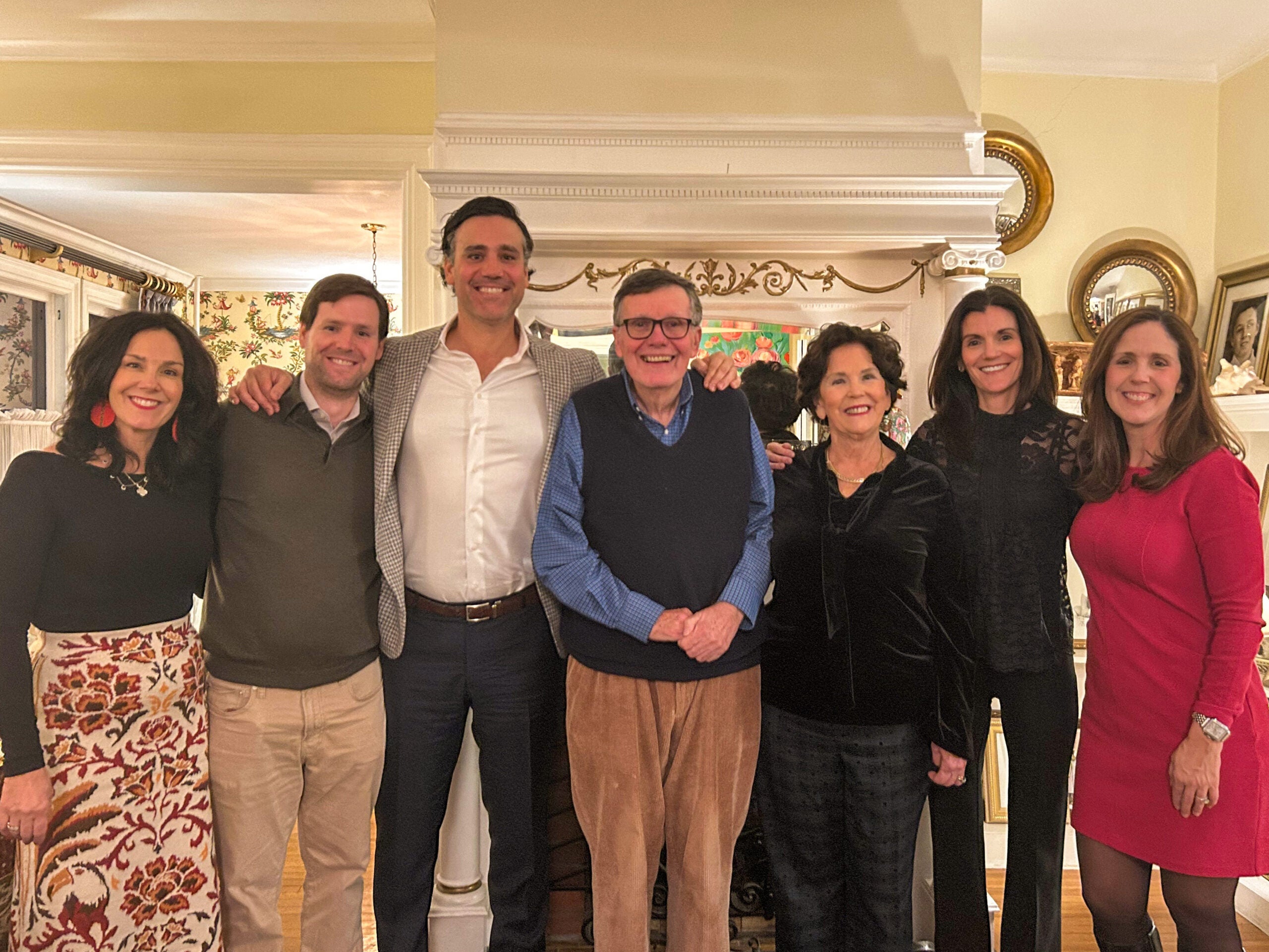 four women and three men stand for a group photo