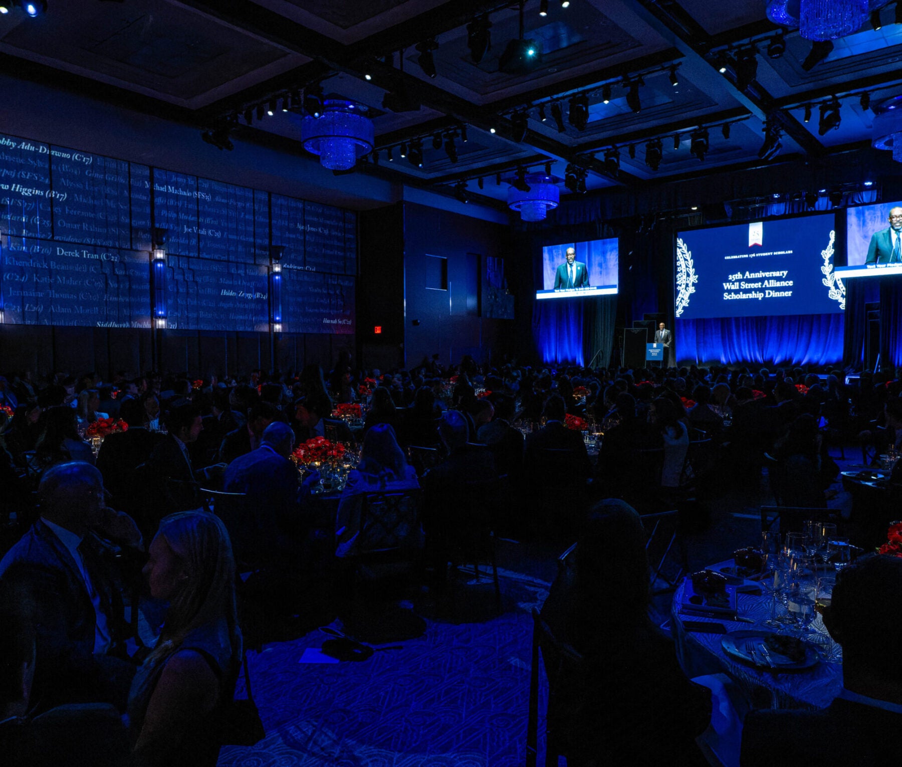 a conference room with tables and a projection screen with the words 
