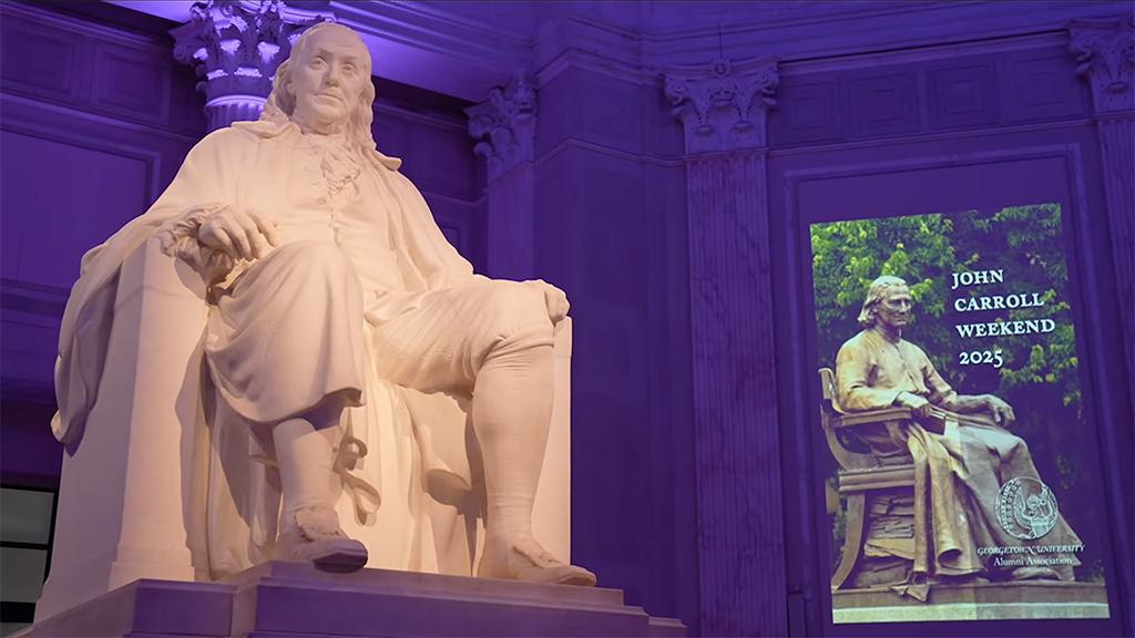 a statue sits next to a banner that says 