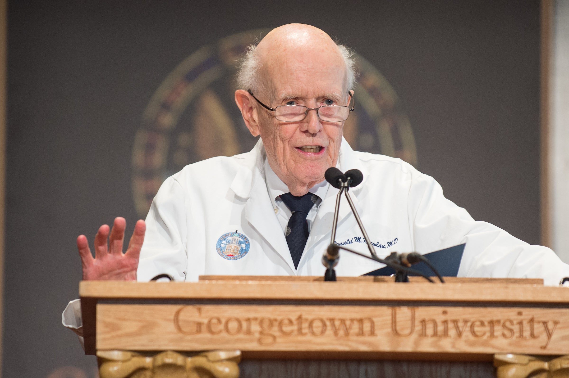 Donald M. Knowlan, M.D., MACP (1929–2025), professor emeritus of medicine, won so many Golden Apple teaching awards that he became the first recipient of Georgetown’s coveted Golden Orchard.