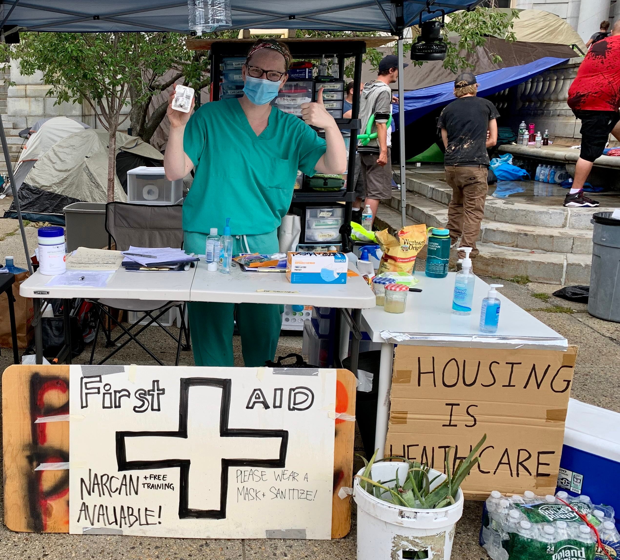 nurse posing at a first aid table