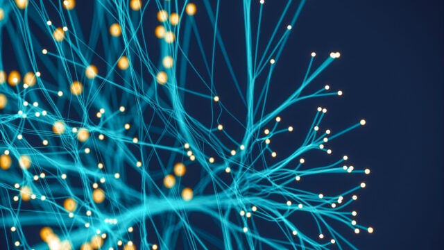 a teal network of electric fibers against a navy background. Photo: iStock