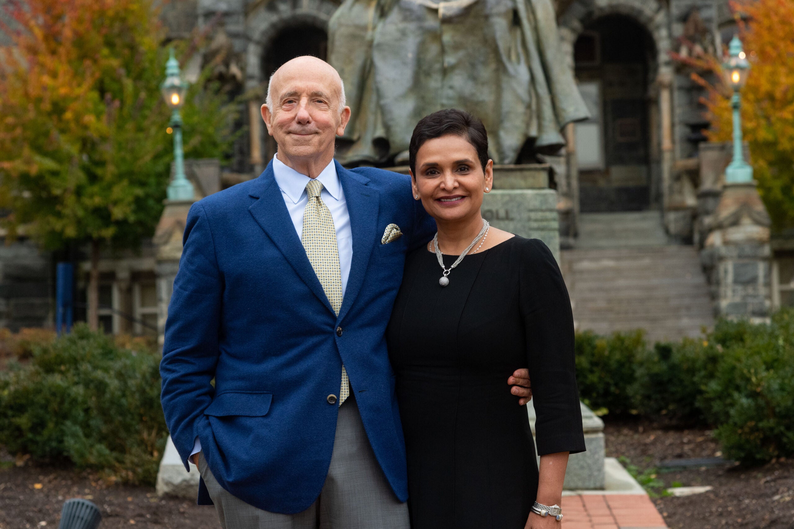 two people stand in front of the John Carroll statue