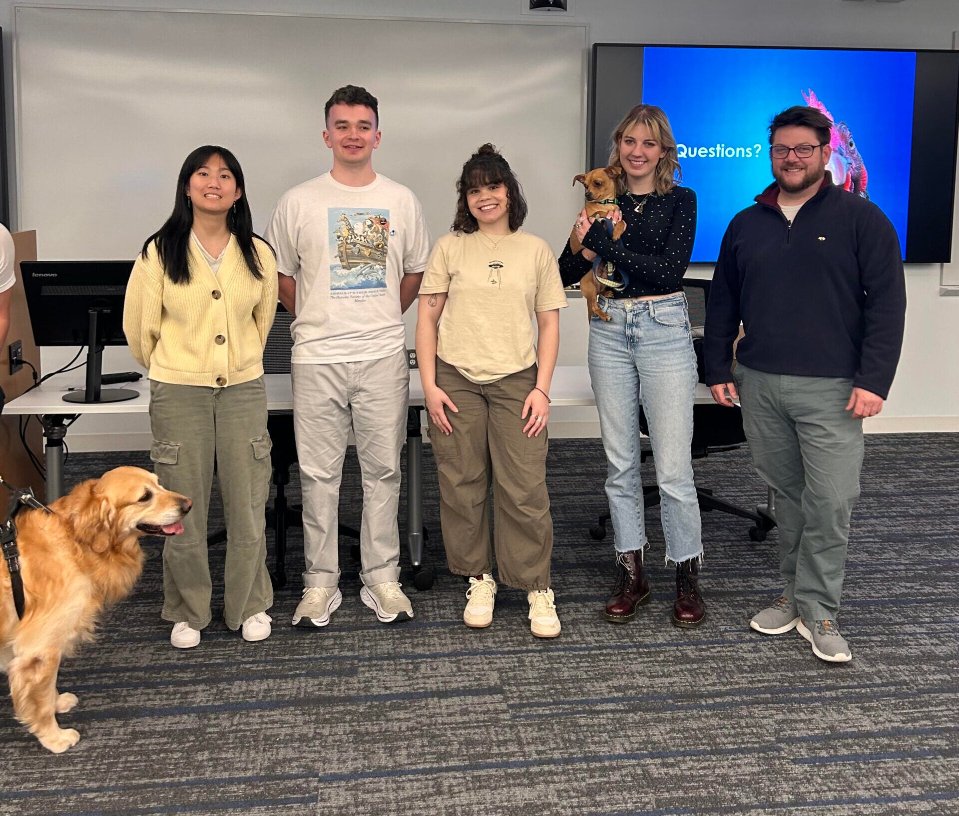 a group of people in a classroom with animals