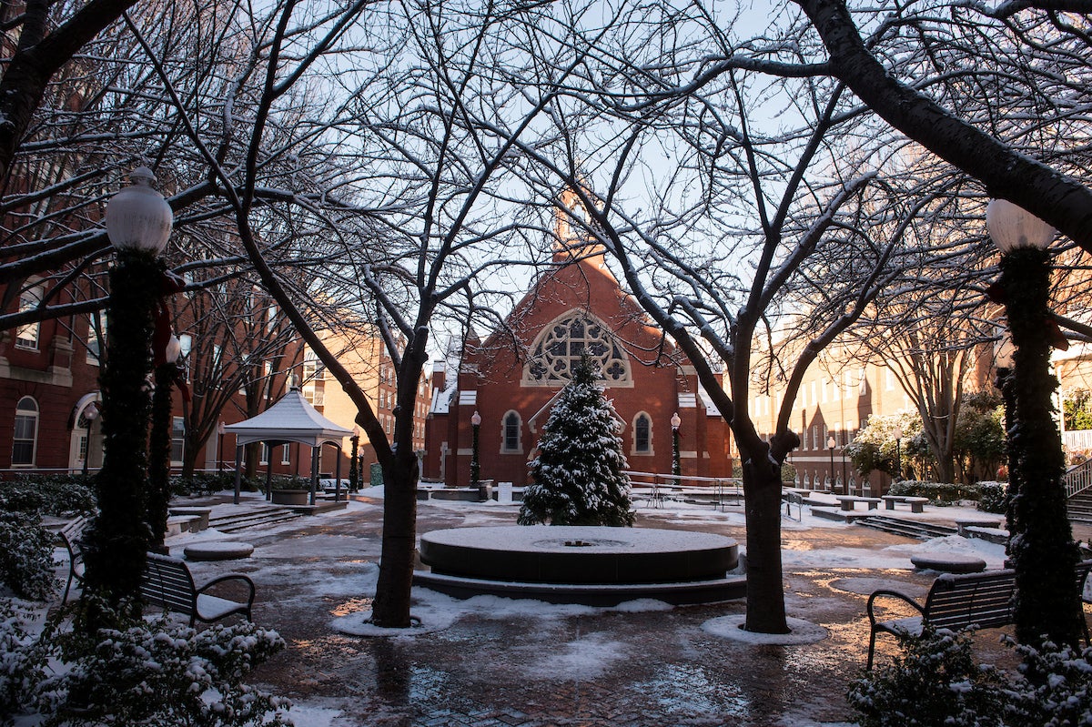 Trees with snow in front of Georgetown University's Dahlgren Chapel of the Sacred Heart.