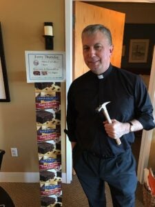 a man stands in front of a tower of brownie mix boxes