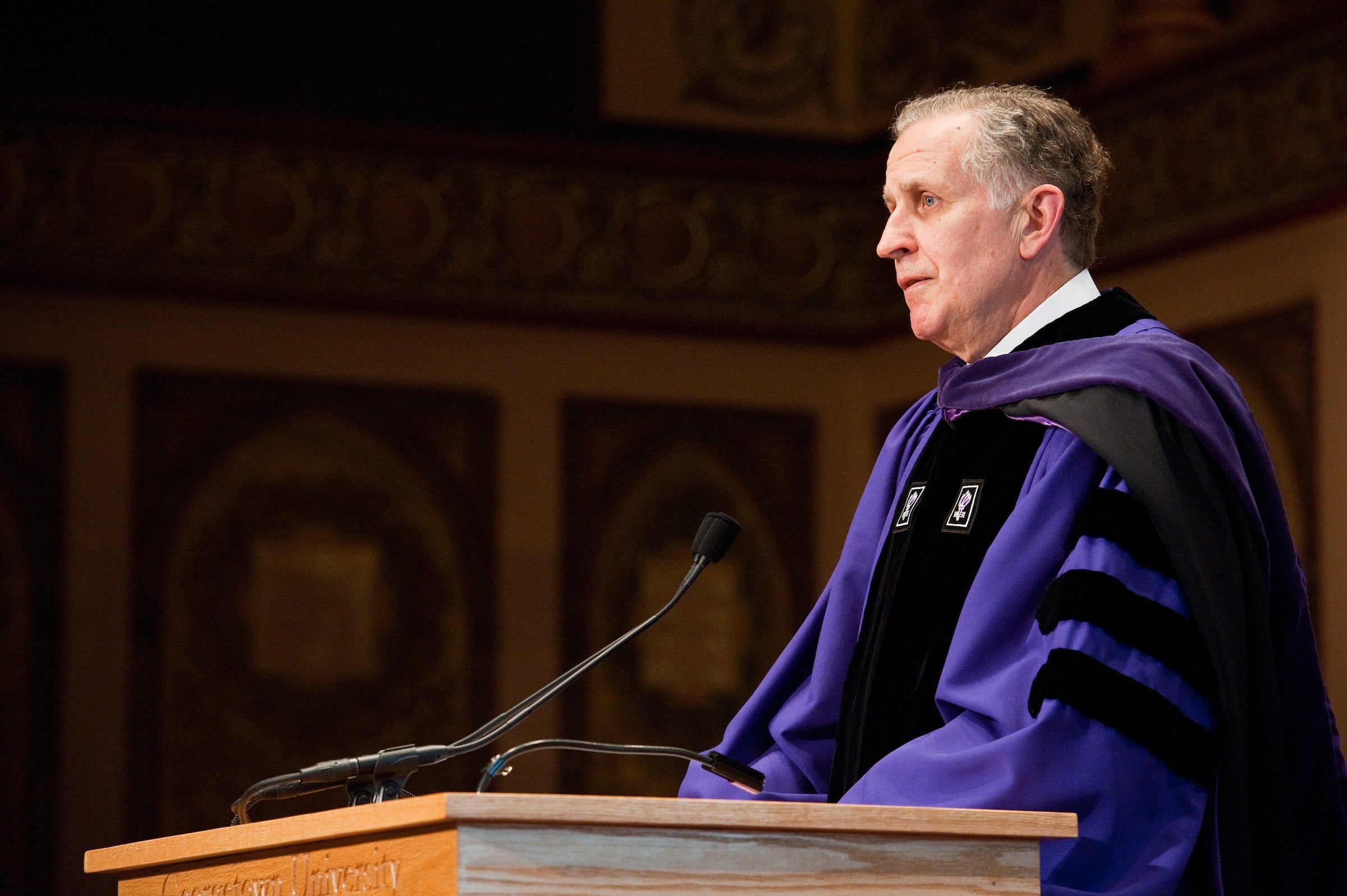 tagliabue speaking at podium at graduation