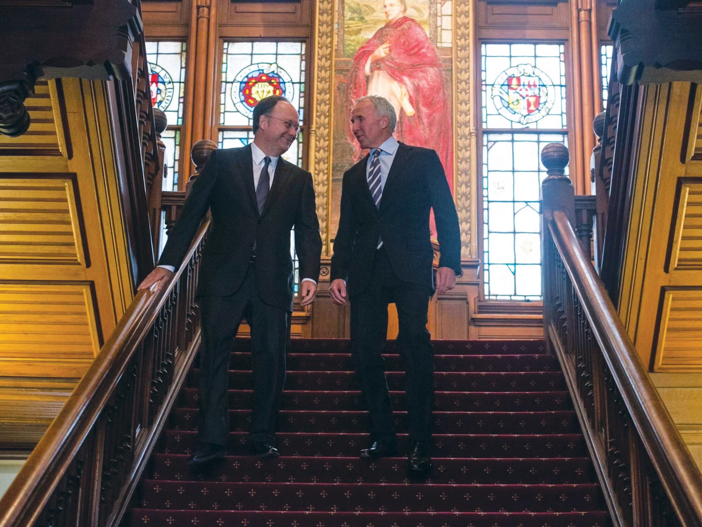 Frank H. McCourt Jr. (right) shares a laugh with then-president John J. DeGioia in 2013.