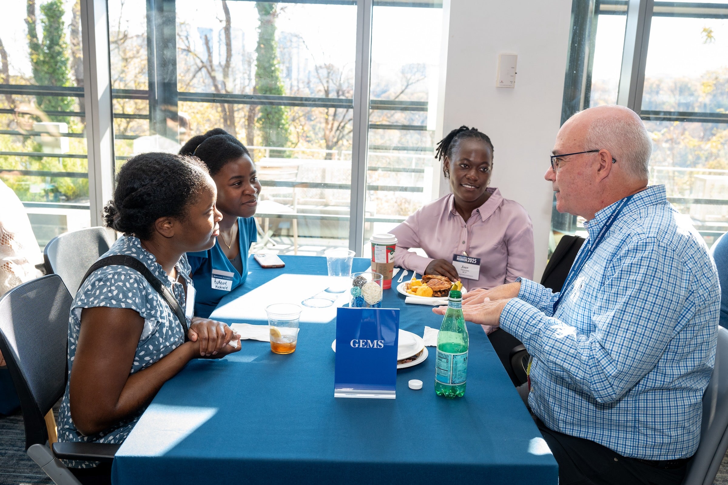 medical dental reunion attendees at table talking