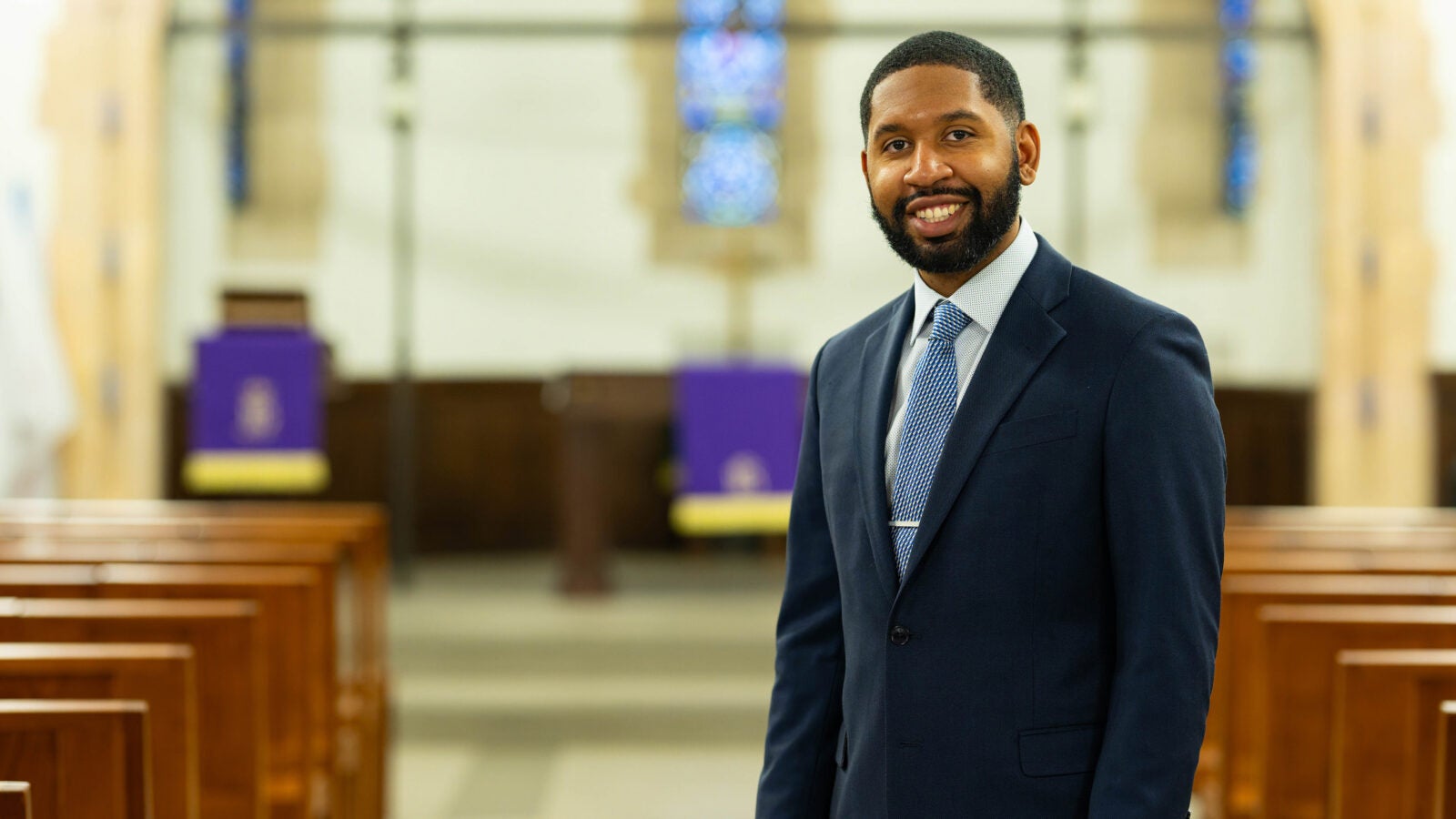 Reverend TauVaughn Toney posing in the chapel