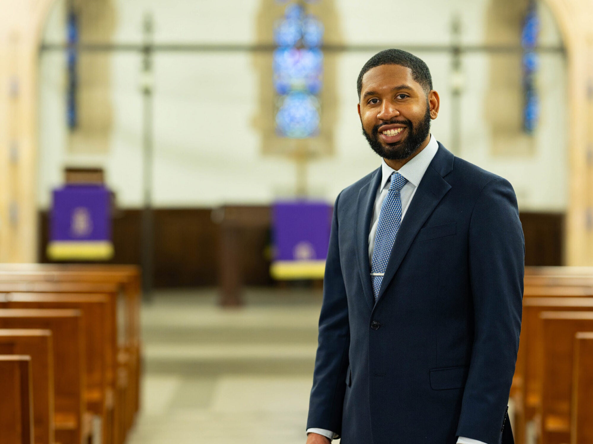 Reverend TauVaughn Toney posing in the chapel