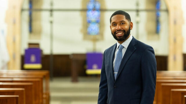 Reverend TauVaughn Toney posing in the chapel