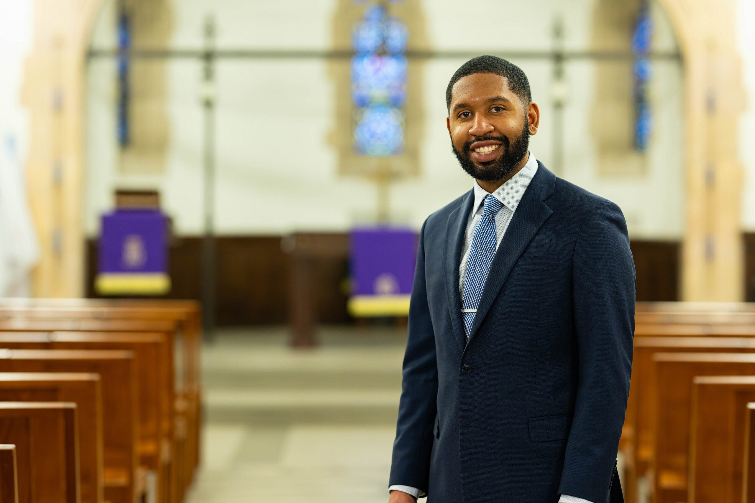 Reverend TauVaughn Toney posing in the chapel