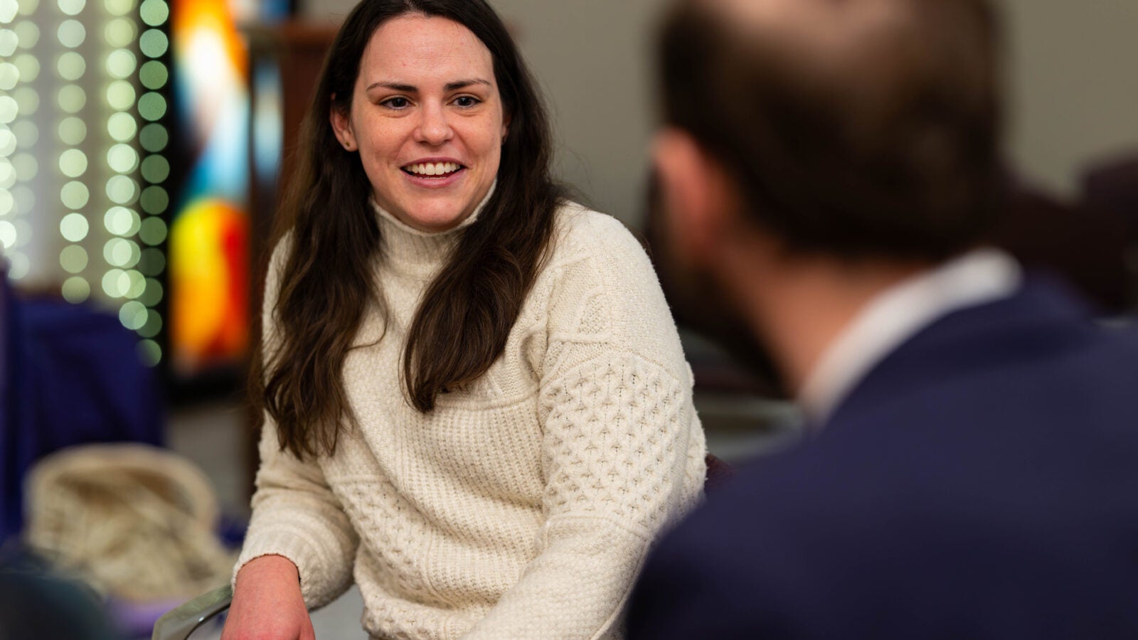 Anna Harty talking with someone and smiling
