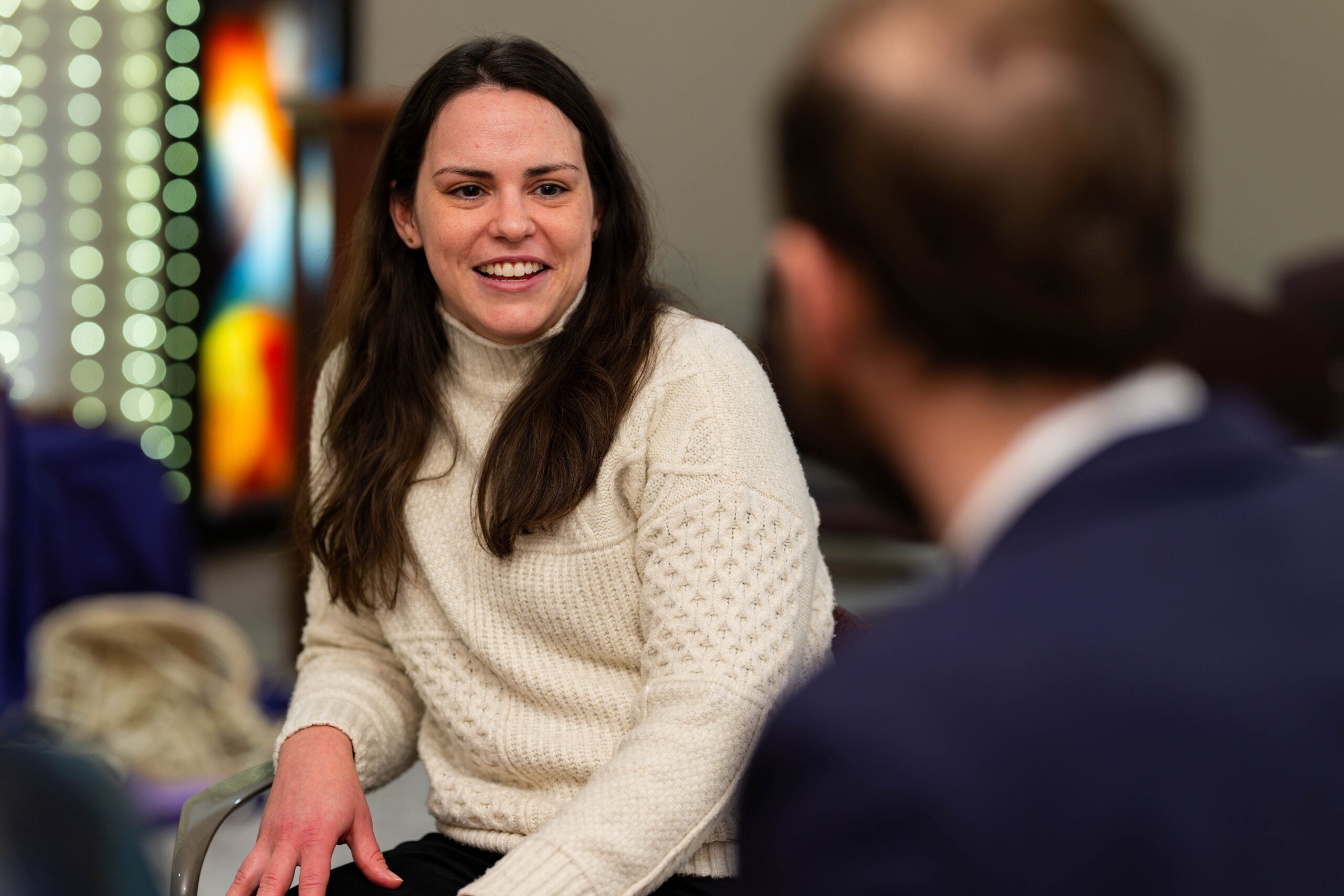 Anna Harty talking with someone and smiling