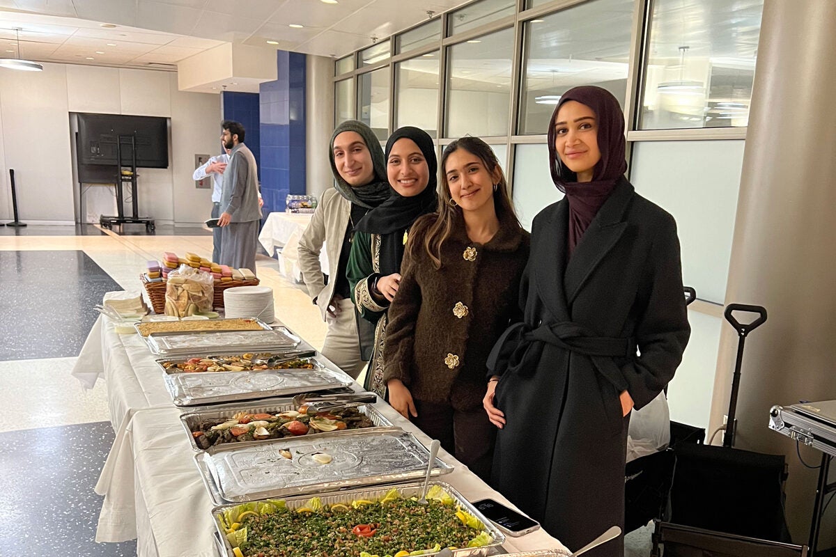 law students posing by food for iftar