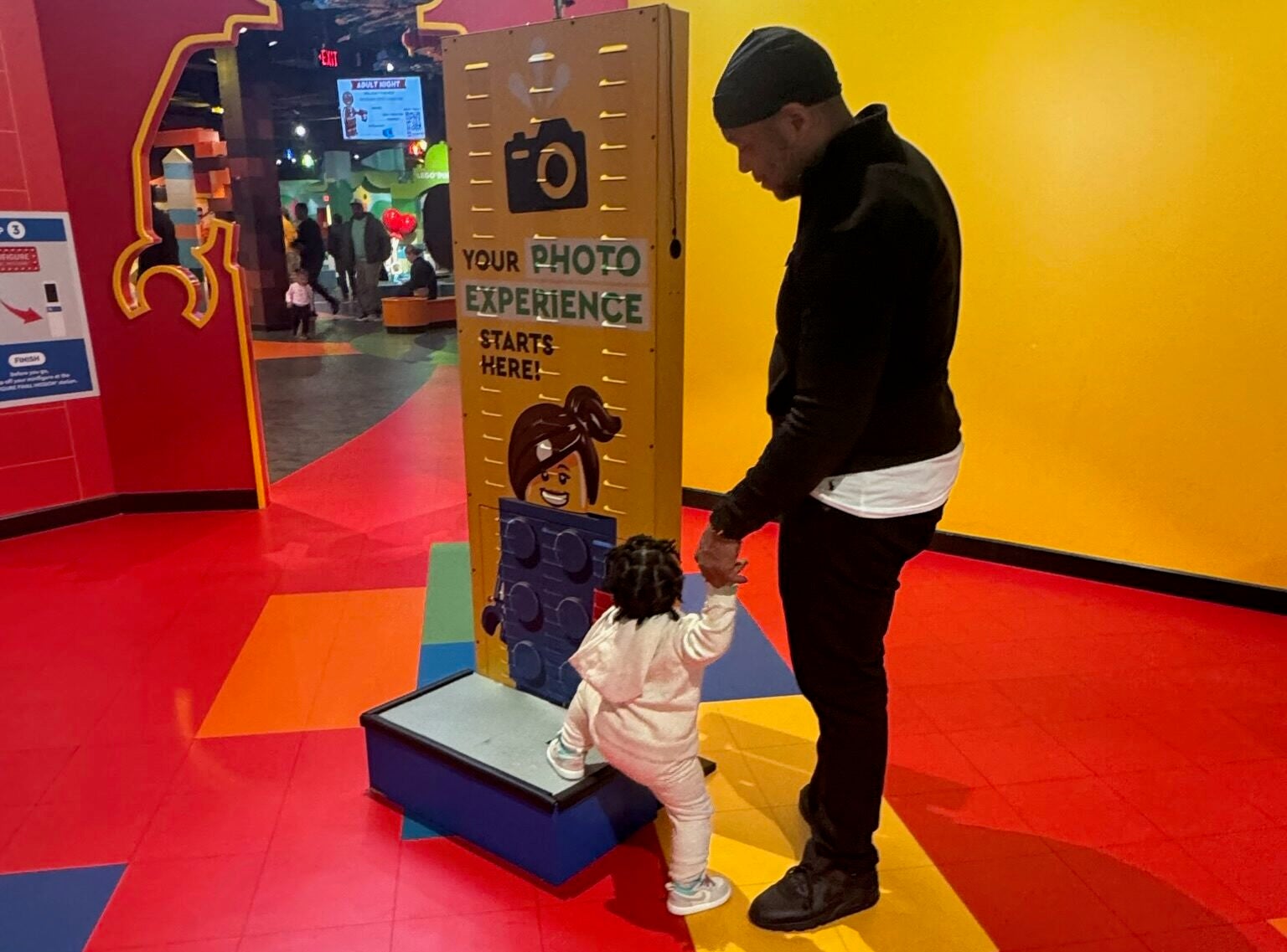 man with a child who is playing on a display