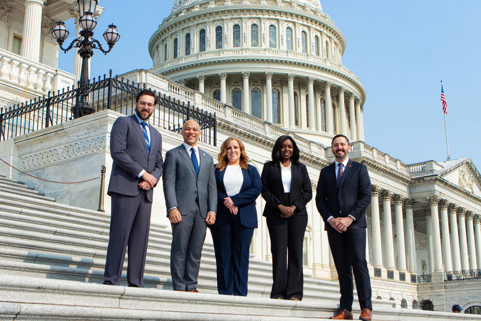 group of people standing in front of Capital Hill