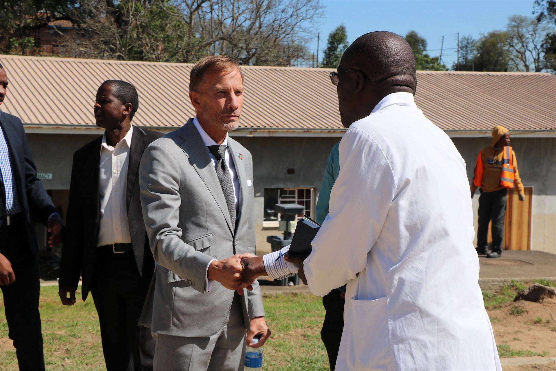 mark dybul shaking hand