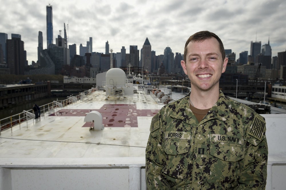 Lt. Andrew “Scott” Morris, M.D., aboard the USNS Comfort with New York City in the background